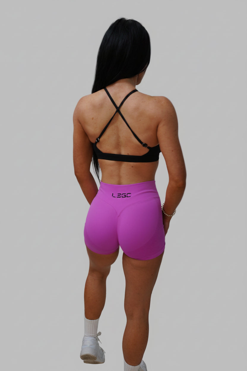 Person in pink shorts and black top.