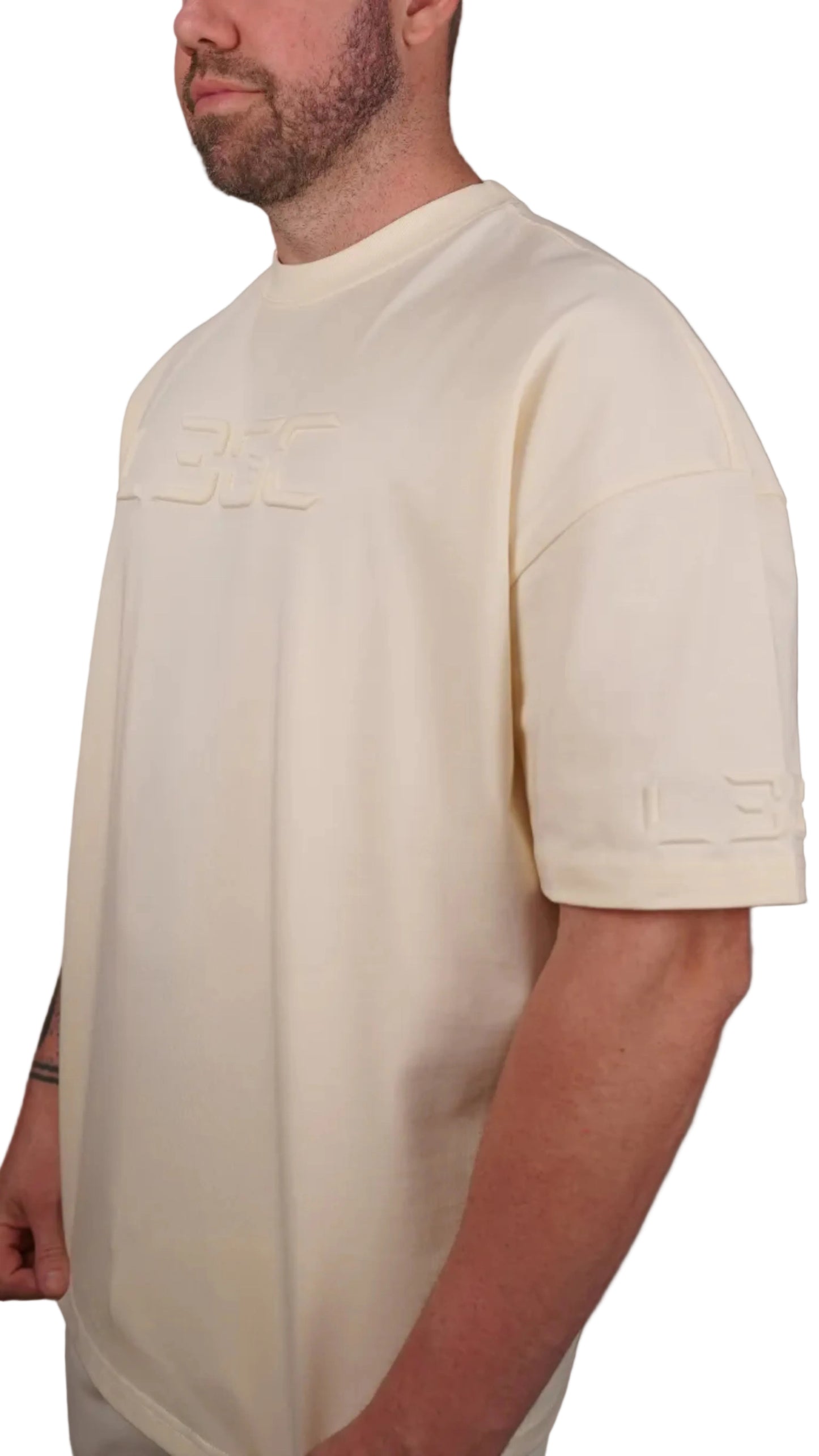 Man wearing a cream shirt against a plain background