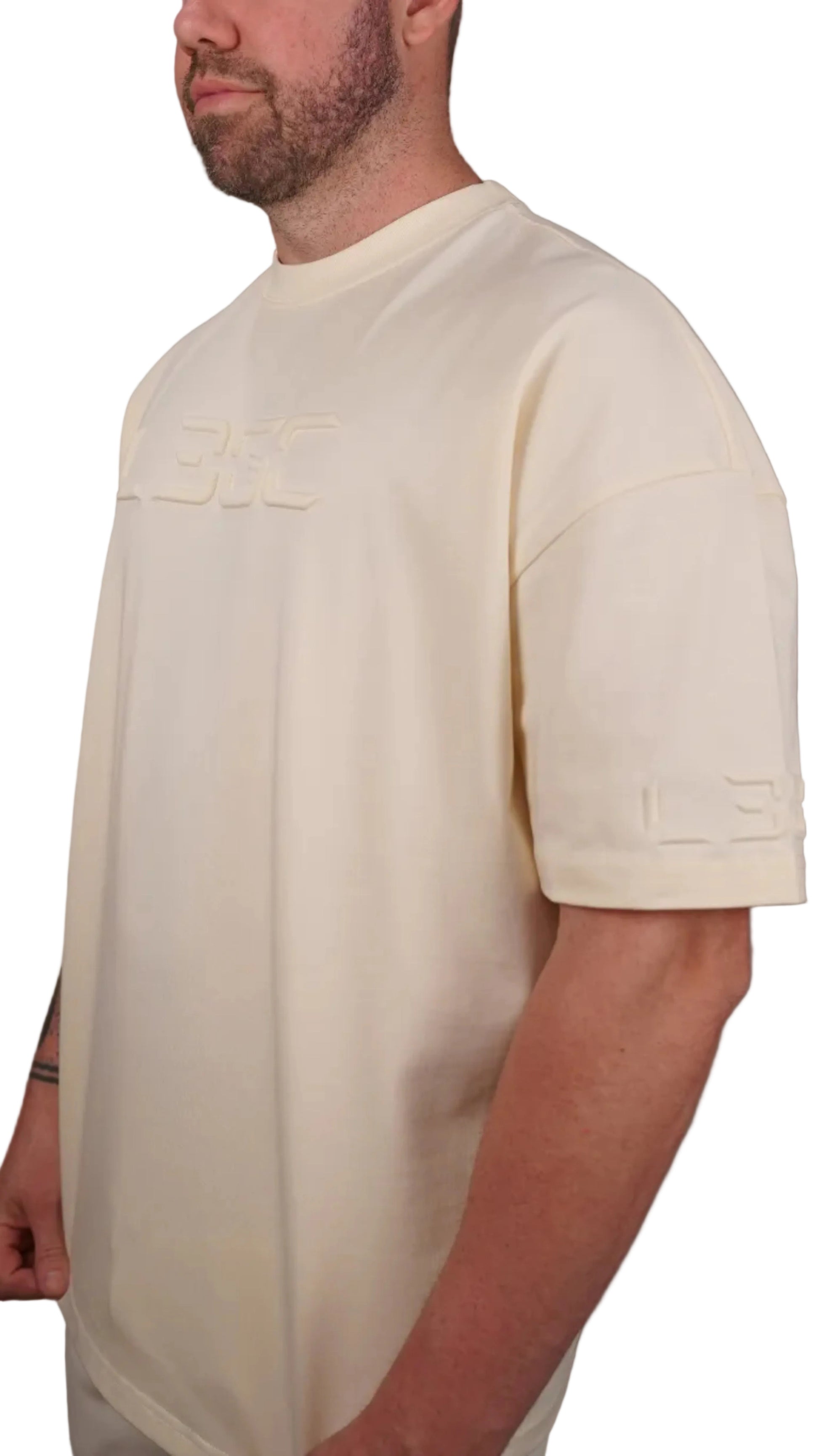Man wearing a cream shirt against a plain background