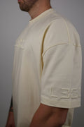 Man wearing a light-colored shirt with a collar against a dark background
