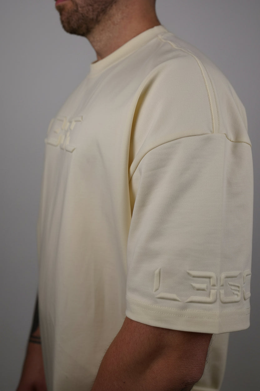 Man wearing a light-colored shirt with a collar against a dark background