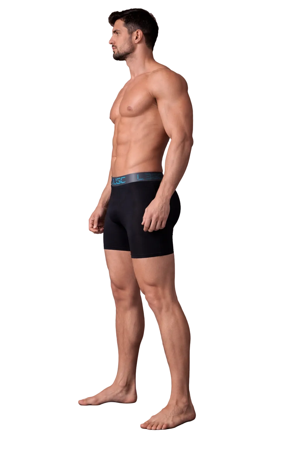 Man wearing black boxer briefs against a dark background