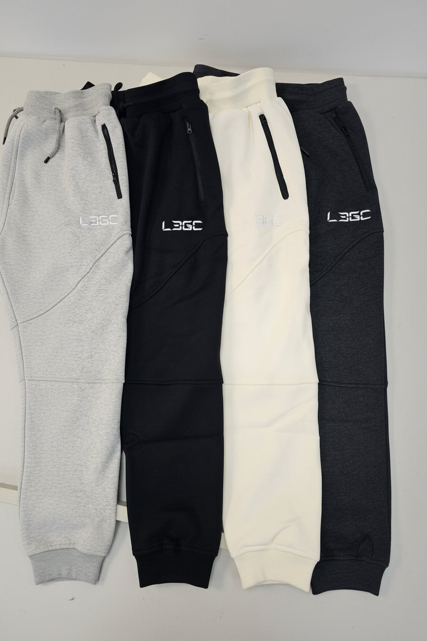 Three pairs of pants in black, white, and gray on a light gray background with '361' branding.