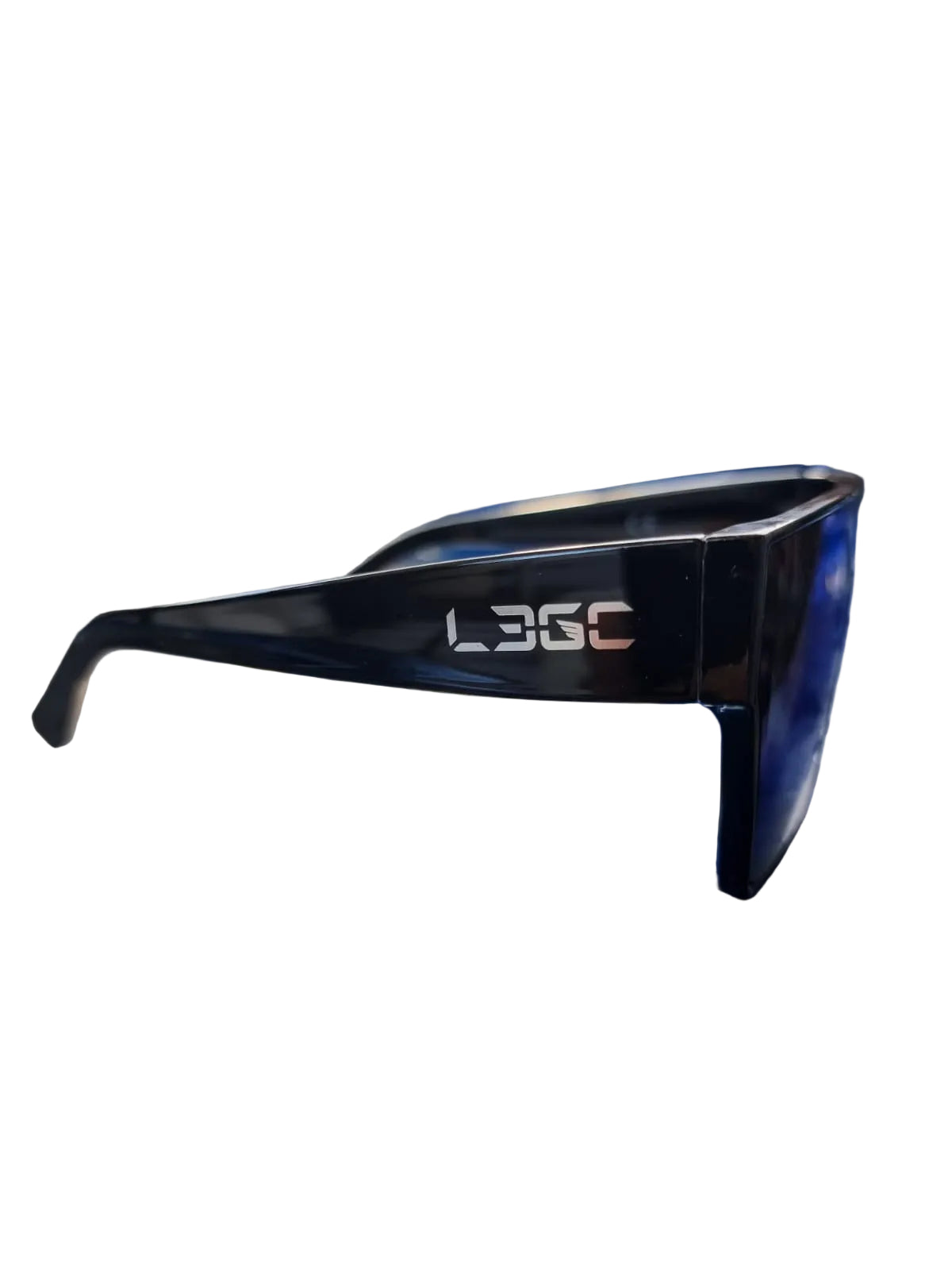 A pair of black sunglasses with a silver logo 'LEGC' etched on the temples, placed on a blue surface with foliage in the background.