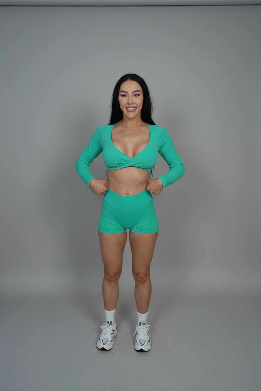 Person wearing a green athletic outfit on a black background