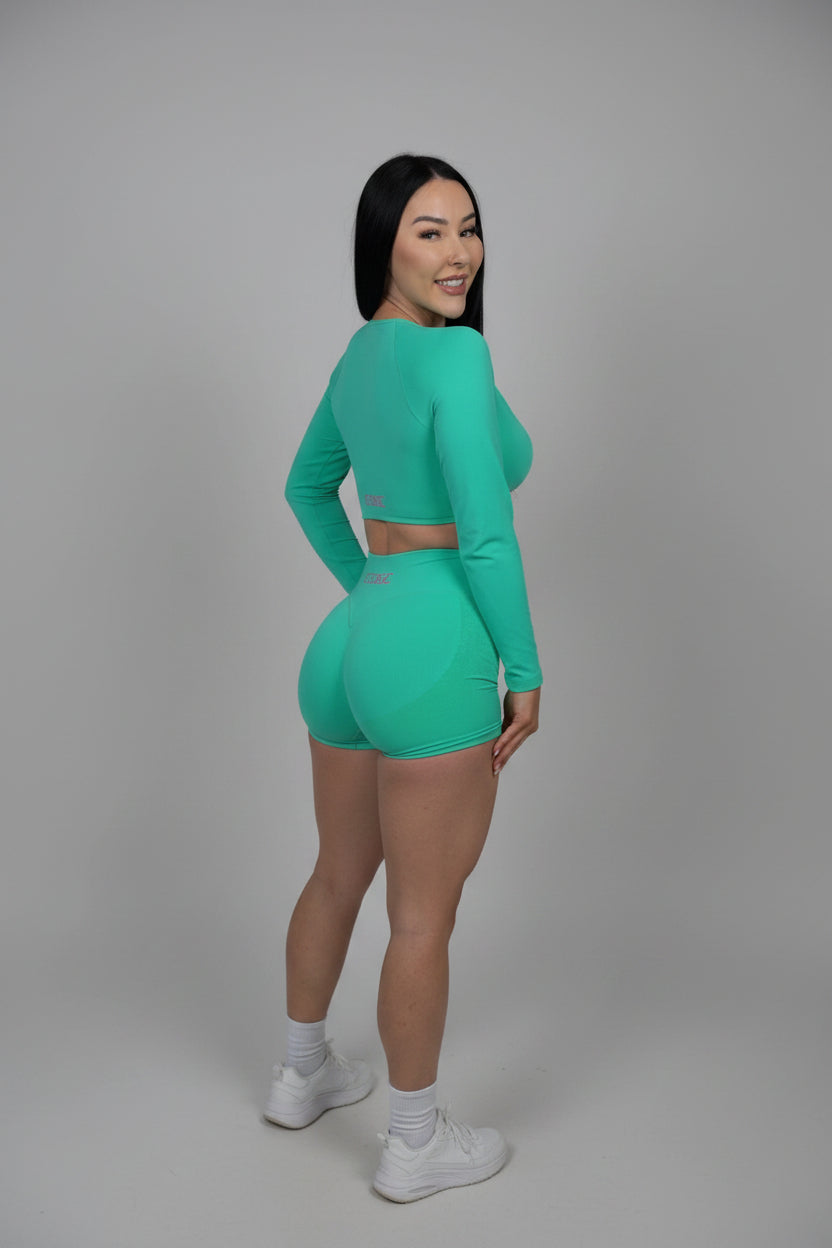 Woman wearing a green outfit on a black background